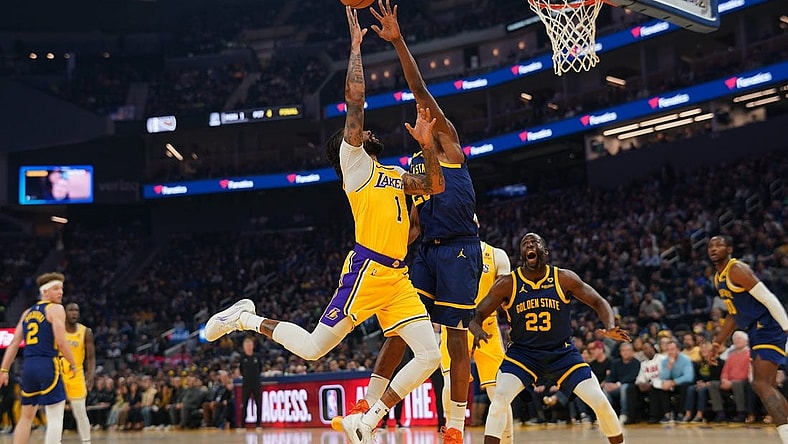 Feb 22, 2024; San Francisco, California, USA; Los Angeles Lakers guard D'Angelo Russell (1) makes a basket over Golden State Warriors forward Andrew Wiggins (22) in the first quarter at the Chase Center. Mandatory Credit: Cary Edmondson-USA TODAY Sports
