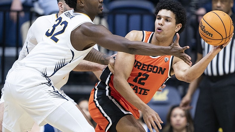 February 22, 2024; Berkeley, California, USA; Oregon State Beavers forward Michael Rataj (12) passes the basketball against California Golden Bears guard Jalen Celestine (32) during the first half at Haas Pavilion. Mandatory Credit: Kyle Terada-USA TODAY Sports