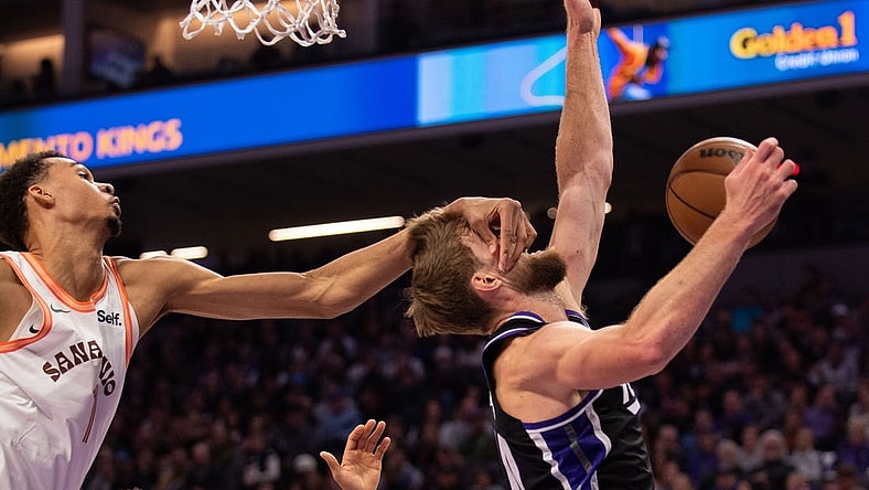 Feb 22, 2024; Sacramento, California, USA; Sacramento Kings forward Domantas Sabonis (10) is fouled by San Antonio Spurs center Victor Wembanyama (1) during the second quarter at Golden 1 Center. Mandatory Credit: Ed Szczepanski-USA TODAY Sports