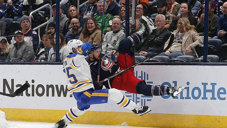 Feb 23, 2024; Columbus, Ohio, USA; Buffalo Sabres defenseman Connor Clifton (75) checks Columbus Blue Jackets center Sean Kuraly (7) during the first period at Nationwide Arena. Mandatory Credit: Russell LaBounty-USA TODAY Sports