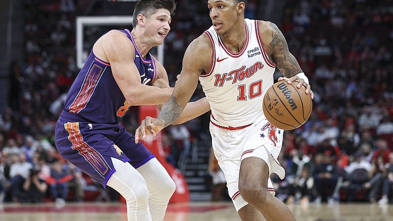 Feb 23, 2024; Houston, Texas, USA; Houston Rockets forward Jabari Smith Jr. (10) dribbles the ball as Phoenix Suns guard Grayson Allen (8) defends during the second quarter at Toyota Center. Mandatory Credit: Troy Taormina-USA TODAY Sports