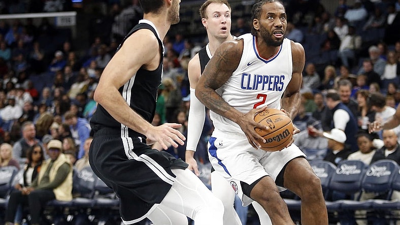 Feb 23, 2024; Memphis, Tennessee, USA; Los Angeles Clippers forward Kawhi Leonard (2) drives to the basket as Memphis Grizzlies forward-center Santi Aldama (7) defends during the second half at FedExForum. Mandatory Credit: Petre Thomas-USA TODAY Sports