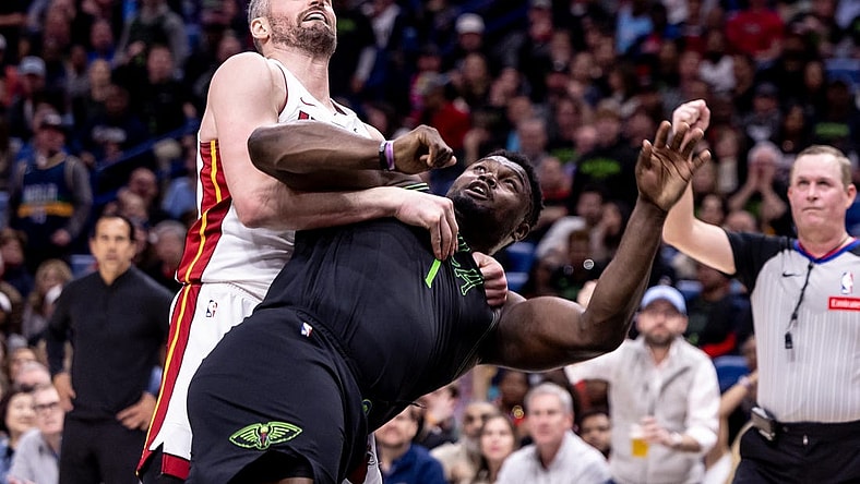Feb 23, 2024; New Orleans, Louisiana, USA;  Miami Heat forward Kevin Love (42) fouls New Orleans Pelicans forward Zion Williamson (1) which starts a melee causing three players to be ejected during the second half at Smoothie King Center. Mandatory Credit: Stephen Lew-USA TODAY Sports