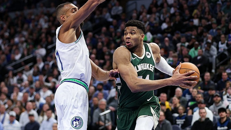 Feb 23, 2024; Minneapolis, Minnesota, USA; Milwaukee Bucks forward Giannis Antetokounmpo (34) works around Minnesota Timberwolves center Rudy Gobert (27) during the first half at Target Center. Mandatory Credit: Matt Krohn-USA TODAY Sports