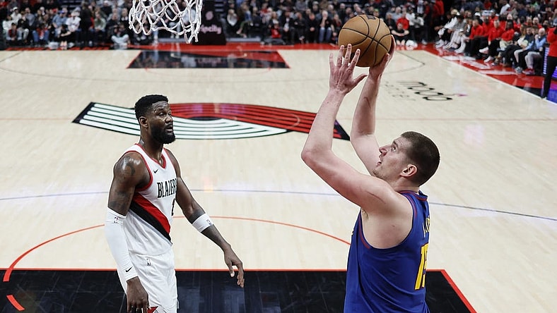 Feb 23, 2024; Portland, Oregon, USA; Denver Nuggets center Nikola Jokic (15) shoots the ball as Portland Trail Blazers center Deandre Anton (2) looks on during the first half at Moda Center. Mandatory Credit: Soobum Im-USA TODAY Sports