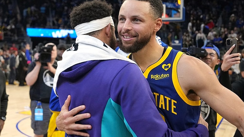 Feb 23, 2024; San Francisco, California, USA; Golden State Warriors guard Stephen Curry (right) hugs Charlotte Hornets guard Seth Curry (left) after the game at Chase Center. Mandatory Credit: Darren Yamashita-USA TODAY Sports