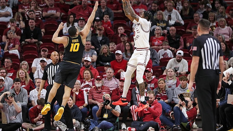 Feb 24, 2024; Fayetteville, Arkansas, USA; Arkansas Razorbacks guard Khalif Battle (0) shoots during the first half as Missouri Tigers guard Nick Honor (10) defends at Bud Walton Arena. Mandatory Credit: Nelson Chenault-USA TODAY Sports