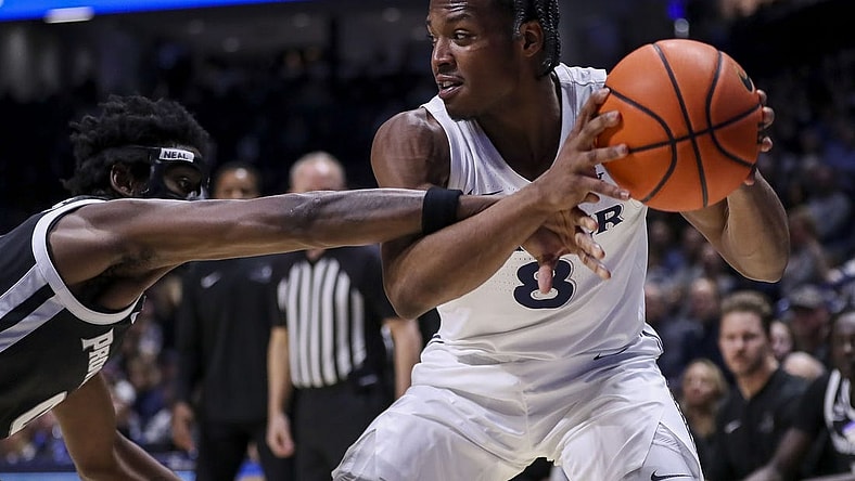 Feb 21, 2024; Cincinnati, Ohio, USA; Xavier Musketeers guard Quincy Olivari (8) holds the ball against Providence Friars guard Ticket Gaines (0) in the first half at Cintas Center. Mandatory Credit: Katie Stratman-USA TODAY Sports