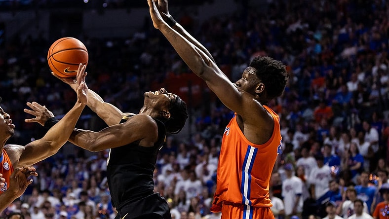 Feb 24, 2024; Gainesville, Florida, USA; Vanderbilt Commodores guard Ezra Manjon (5) attempts a layup over Florida Gators forward Tyrese Samuel (4) during the first half at Exactech Arena at the Stephen C. O'Connell Center. Mandatory Credit: Matt Pendleton-USA TODAY Sports