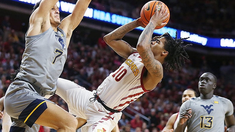 Iowa State Cyclones guard Keshon Gilbert (10) shoots the ball as West Virginia Mountaineers guard Jesse Edwards (7) defends during the first half in the Big-12 conference showdown of a NCAA college basketball at Hilton Coliseum on Feb. x, 2024, in Ames, Iowa.