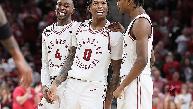 Feb 24, 2024; Fayetteville, Arkansas, USA; Arkansas Razorbacks guard Khalif Battle (0) celebrates with guards Davonte Davis (4) and Tramon Mark (12) after making a three point shot in the second half against the Missouri Tigers at Bud Walton Arena. Arkansas won 88-73. Mandatory Credit: Nelson Chenault-USA TODAY Sports