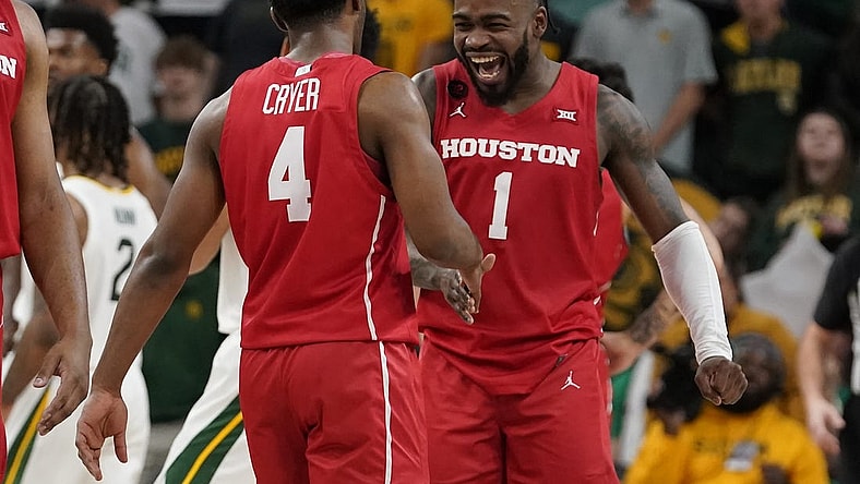 Feb 24, 2024; Waco, Texas, USA; Houston Cougars guard L.J. Cryer (4) and guard Jamal Shead (1) react in the closing moments of overtime against the Baylor Bears at Paul and Alejandra Foster Pavilion. Mandatory Credit: Raymond Carlin III-USA TODAY Sports