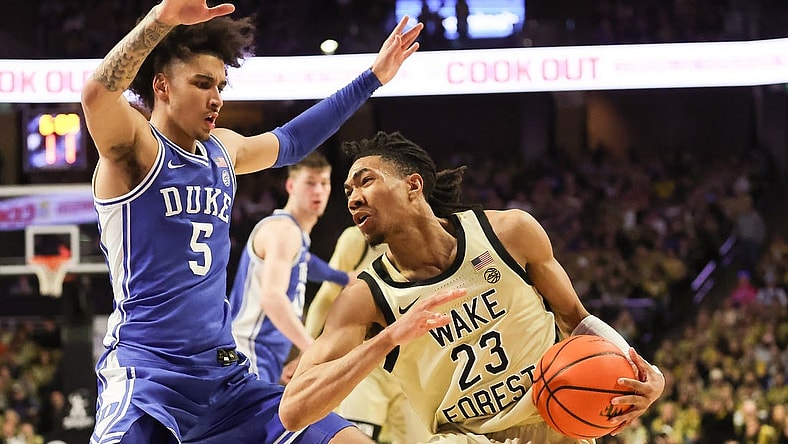 Feb 24, 2024; Winston-Salem, North Carolina, USA;  Wake Forest Demon Deacons guard Hunter Sallis (23) fights for position against Duke Blue Devils guard Tyrese Proctor (5) during the first half at Lawrence Joel Veterans Memorial Coliseum. Mandatory Credit: Cory Knowlton-USA TODAY Sports