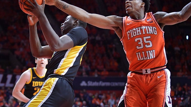 Feb 24, 2024; Champaign, Illinois, USA;  Illinois Fighting Illini forward Amani Hansberry (35) tries to knock the ball from Iowa Hawkeyes forward Ladji Dembele (13) during the first half at State Farm Center. Mandatory Credit: Ron Johnson-USA TODAY Sports