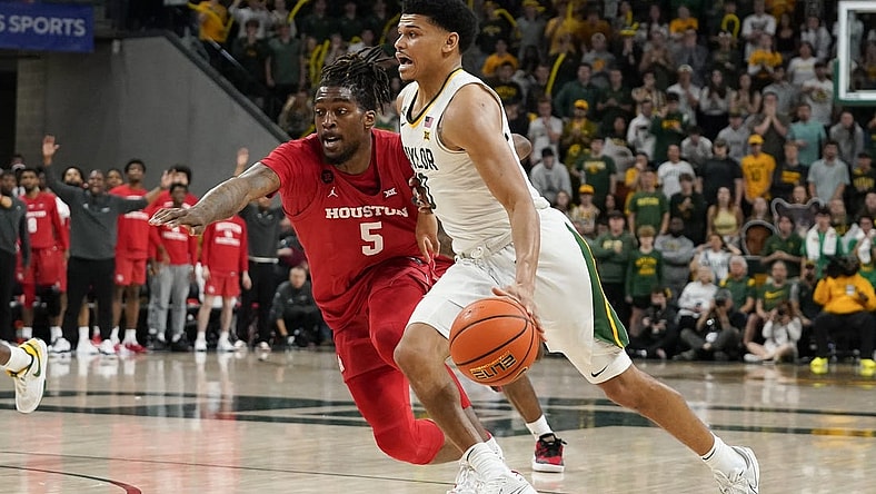 Feb 24, 2024; Waco, Texas, USA; Baylor Bears guard RayJ Dennis (10) works past  Houston Cougars forward Ja'Vier Francis (5) during the second half at Paul and Alejandra Foster Pavilion. Mandatory Credit: Raymond Carlin III-USA TODAY Sports