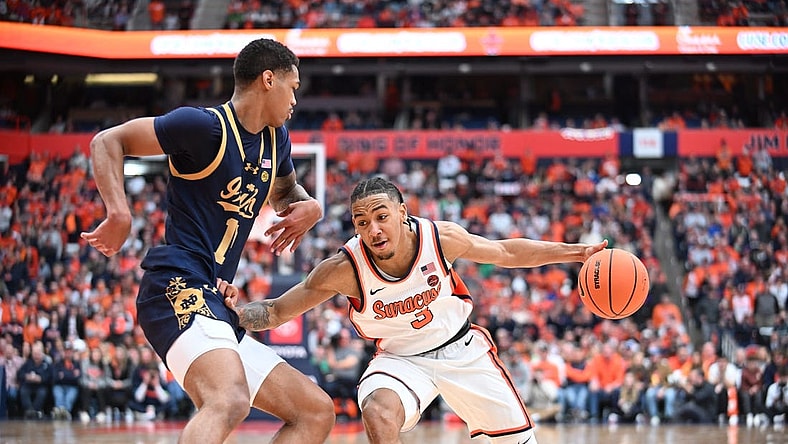 Feb 24, 2024; Syracuse, New York, USA; Syracuse Orange guard Judah Mintz (3) tries to move the ball past Notre Dame Fighting Irish forward Tae Davis (13) in the second half at the JMA Wireless Dome. Mandatory Credit: Mark Konezny-USA TODAY Sports