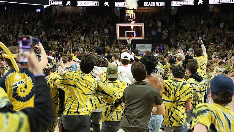Feb 24, 2024; Winston-Salem, North Carolina, USA;  Wake Forest Demon Deacons students storm the court after Wake Forest wins at Lawrence Joel Veterans Memorial Coliseum. Mandatory Credit: Cory Knowlton-USA TODAY Sports