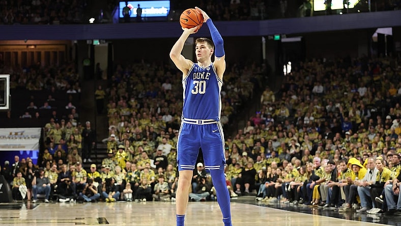 Feb 24, 2024; Winston-Salem, North Carolina, USA;  Duke Blue Devils center Kyle Filipowski (30) makes a three point shot during the second half against the Wake Forest Demon Deacons at Lawrence Joel Veterans Memorial Coliseum. Mandatory Credit: Cory Knowlton-USA TODAY Sports