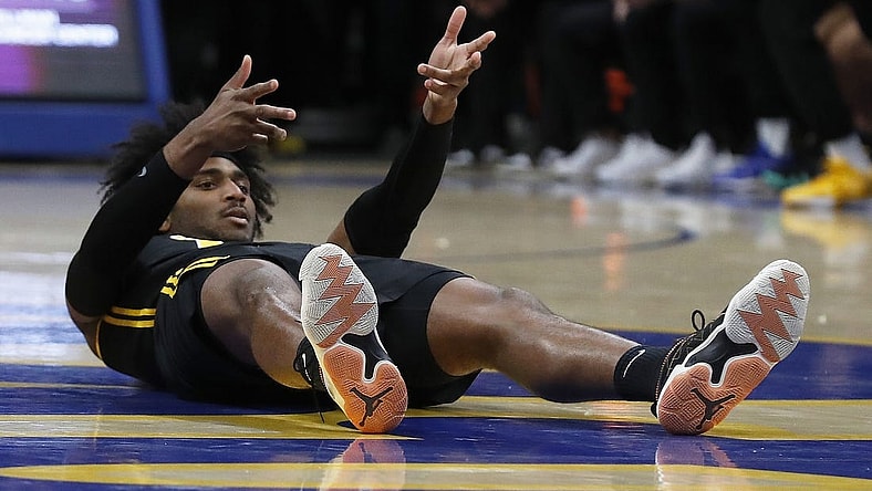Feb 24, 2024; Pittsburgh, Pennsylvania, USA;  Pittsburgh Panthers forward Blake Hinson (2) reacts after making a three point basket despite being knocked to the court by the Virginia Tech Hokies during the first half at the Petersen Events Center. Mandatory Credit: Charles LeClaire-USA TODAY Sports