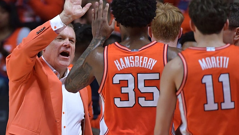 Feb 24, 2024; Champaign, Illinois, USA; Illinois Fighting Illini head coach Brad Underwood gives players a hand during the second half against the Iowa Hawkeyes at State Farm Center. Mandatory Credit: Ron Johnson-USA TODAY Sports