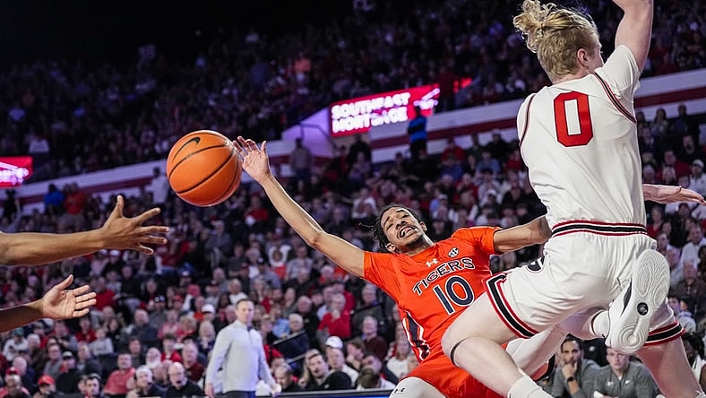 Feb 24, 2024; Athens, Georgia, USA; Auburn Tigers guard Chad Baker-Mazara (10) and Georgia Bulldogs guard Blue Cain (0) collide during the first half at Stegeman Coliseum. Mandatory Credit: Dale Zanine-USA TODAY Sports