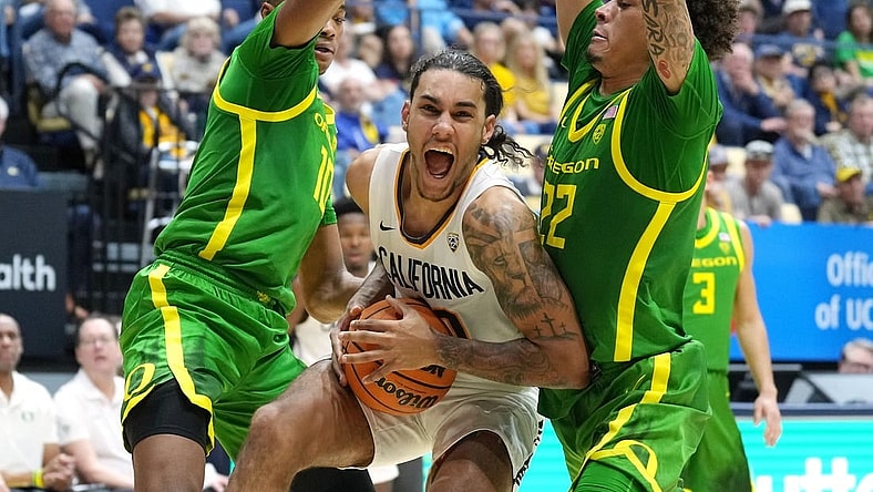Feb 24, 2024; Berkeley, California, USA; California Golden Bears guard Jaylon Tyson (center) drives against Oregon Ducks forward Kwame Evans Jr. (10) and guard Jadrian Tracey (22) during the first half at Haas Pavilion. Mandatory Credit: Darren Yamashita-USA TODAY Sports