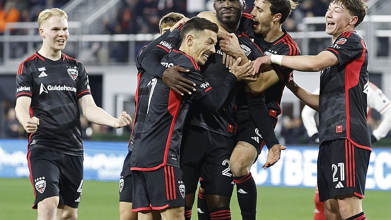 Feb 24, 2024; Washington, District of Columbia, USA; D.C. United forward Christian Benteke (20) celebrates with teammates after scoring a goal against the New England Revolution in the first half at Audi Field. Mandatory Credit: Geoff Burke-USA TODAY Sports