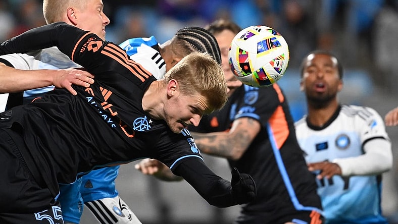 Feb 24, 2024; Charlotte, North Carolina, USA;  New York City midfielder Keaton Parks (55) heads the ball as Charlotte FC Junior Urso (30) defends in the first half at Bank of America Stadium. Mandatory Credit: Bob Donnan-USA TODAY Sports