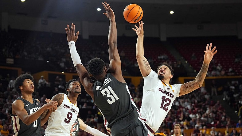 Feb 24, 2024; Tempe, Arizona, USA; Arizona State Sun Devils guard Jose Perez (12) shoots over Washington State Cougars guard Kymany Houinsou (31) during the second half at Desert Financial Arena. Mandatory Credit: Joe Camporeale-USA TODAY Sports