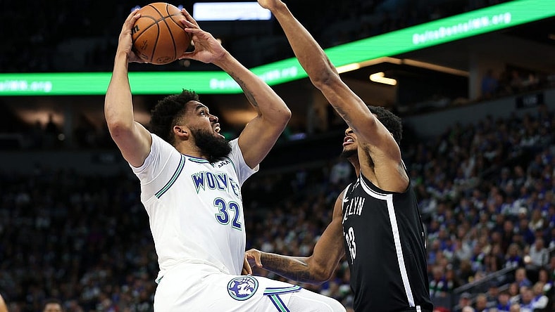 Feb 24, 2024; Minneapolis, Minnesota, USA; Minnesota Timberwolves center Karl-Anthony Towns (32) shoots as Brooklyn Nets center Nic Claxton (33) defends during the first half at Target Center. Mandatory Credit: Matt Krohn-USA TODAY Sports