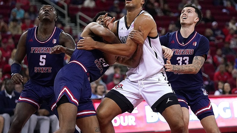 Feb 24, 2024; Fresno, California, USA; San Diego State Aztecs forward Jaedon LeDee (13) battles for position with Fresno State Bulldogs guard Leo Colimerio (23) and guard Steven Vasquez Jr. (33) in the first half at the Save Mart Center. Mandatory Credit: Cary Edmondson-USA TODAY Sports