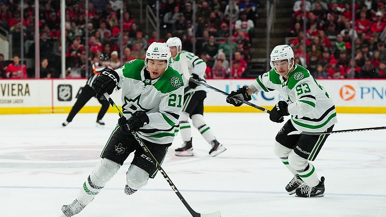 Feb 24, 2024; Raleigh, North Carolina, USA;  Dallas Stars left wing Jason Robertson (21) skates with the puck next to center Wyatt Johnston (53) during the second period against the Carolina Hurricanes at PNC Arena. Mandatory Credit: James Guillory-USA TODAY Sports