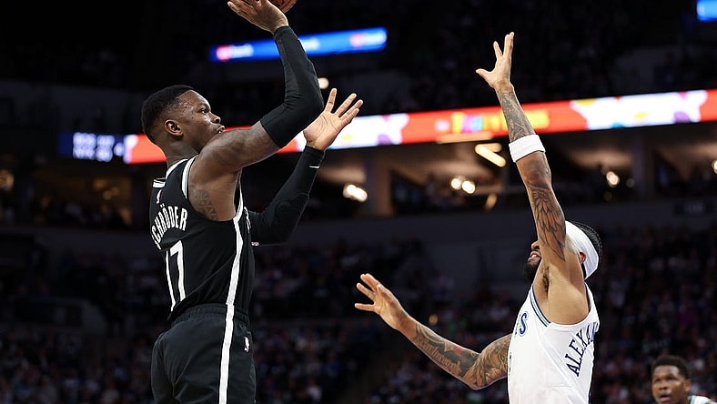 Feb 24, 2024; Minneapolis, Minnesota, USA; Brooklyn Nets guard Dennis Schroder (17) shoots as Minnesota Timberwolves guard Nickeil Alexander-Walker (9) defends during the second half at Target Center. Mandatory Credit: Matt Krohn-USA TODAY Sports