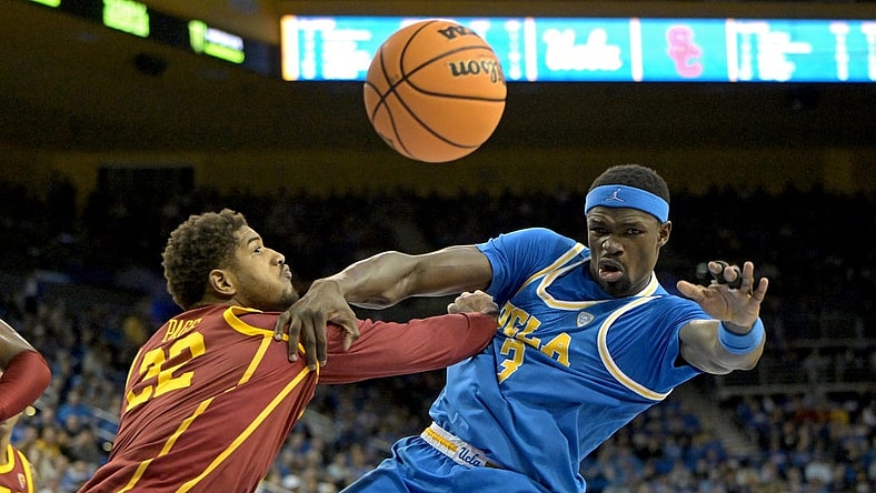 Feb 24, 2024; Los Angeles, California, USA;  USC Trojans forward Arrinten Page (22) and UCLA Bruins forward Adem Bona (3) go for a rebound in the first half at Pauley Pavilion presented by Wescom. Mandatory Credit: Jayne Kamin-Oncea-USA TODAY Sports