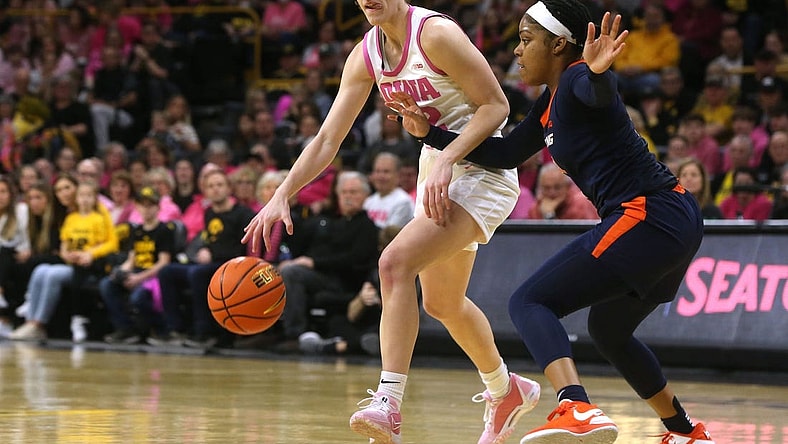 Iowa's Caitlin Clark (22) dribbles as Illinois   s Makira Cook (3) defends Saturday, Feb. 24, 2024 at Carver-Hawkeye Arena.