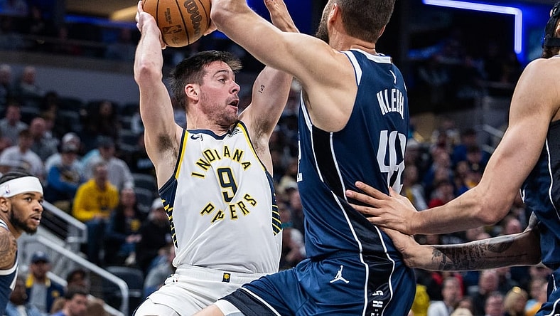 Feb 25, 2024; Indianapolis, Indiana, USA; Indiana Pacers guard T.J. McConnell (9) passes the ball while Dallas Mavericks forward Maxi Kleber (42) defends in the first half at Gainbridge Fieldhouse. Mandatory Credit: Trevor Ruszkowski-USA TODAY Sports