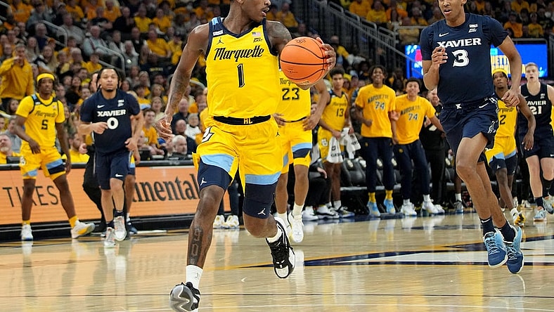 Marquette guard Kam Jones (1) scores on a fast break during the first half of their game against Xavier Sunday, February 25, 2023 at Fiserv Forum in Milwaukee, Wisconsin.