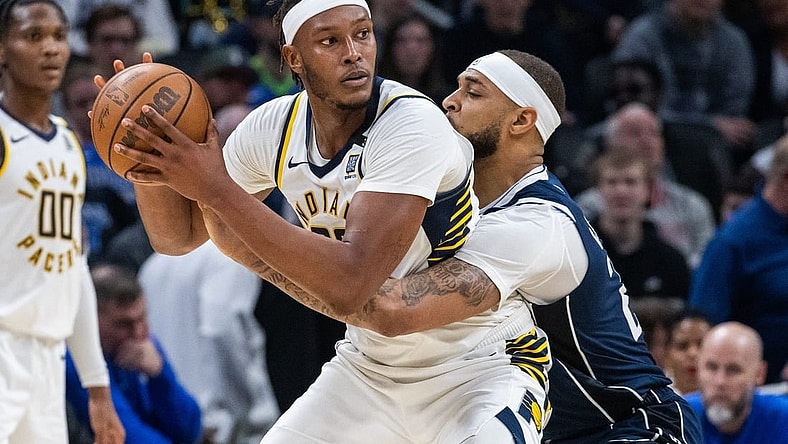 Feb 25, 2024; Indianapolis, Indiana, USA; Indiana Pacers center Myles Turner (33) holds the ball while Dallas Mavericks center Daniel Gafford (21) defends in the second half at Gainbridge Fieldhouse. Mandatory Credit: Trevor Ruszkowski-USA TODAY Sports