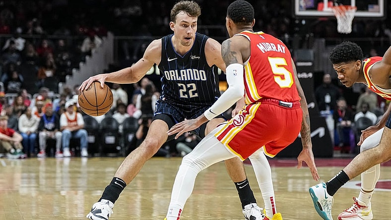 Feb 25, 2024; Atlanta, Georgia, USA; Orlando Magic forward Franz Wagner (22) dribbles against Atlanta Hawks guard Dejounte Murray (5) during the first half at State Farm Arena. Mandatory Credit: Dale Zanine-USA TODAY Sports