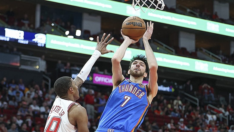 Feb 25, 2024; Houston, Texas, USA; Oklahoma City Thunder forward Chet Holmgren (7) shoots the ball as Houston Rockets forward Jabari Smith Jr. (10) defends during the third quarter at Toyota Center. Mandatory Credit: Troy Taormina-USA TODAY Sports