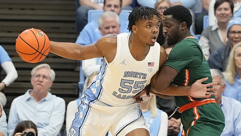 Feb 26, 2024; Chapel Hill, North Carolina, USA; North Carolina Tar Heels forward Harrison Ingram (55) with the ball as Miami (Fl) Hurricanes guard Bensley Joseph (4) defends in the first half at Dean E. Smith Center. Mandatory Credit: Bob Donnan-USA TODAY Sports