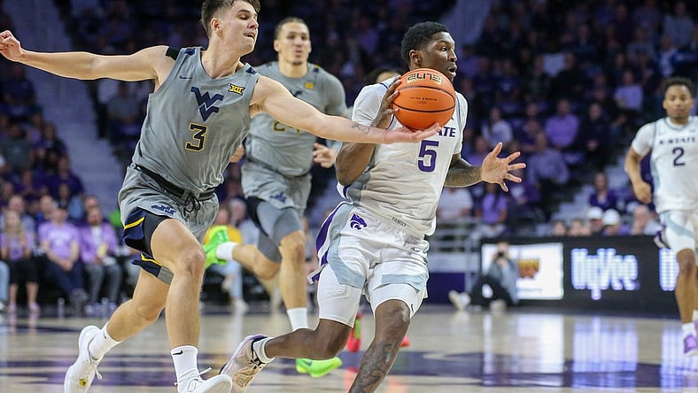 Feb 26, 2024; Manhattan, Kansas, USA; West Virginia Mountaineers guard Kerr Kriisa (3) knocks the ball away from Kansas State Wildcats guard Cam Carter (5) during the first half at Bramlage Coliseum. Mandatory Credit: Scott Sewell-USA TODAY Sports