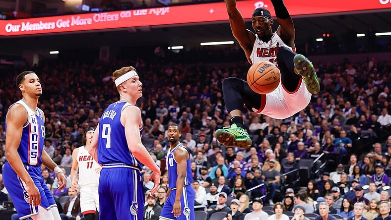 Feb 26, 2024; Sacramento, California, USA; Miami Heat center Bam Adebayo (13) dunks the ball against Sacramento Kings guard Kevin Huerter (9) during the first quarter at Golden 1 Center. Mandatory Credit: Sergio Estrada-USA TODAY Sports