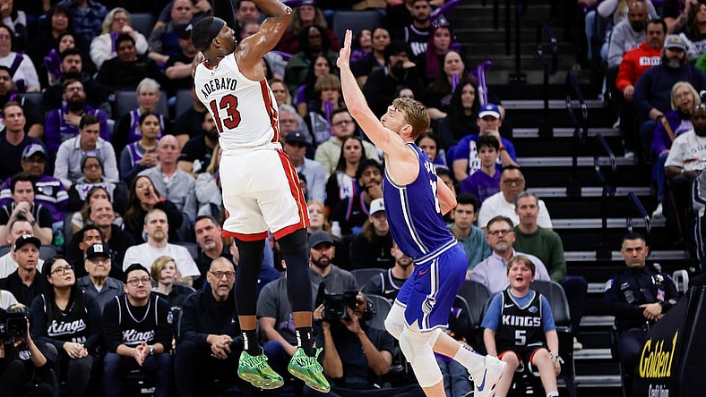 Feb 26, 2024; Sacramento, California, USA; Miami Heat center Bam Adebayo (13) shoots the ball over Sacramento Kings forward Domantas Sabonis (10) during the fourth quarter at Golden 1 Center. Mandatory Credit: Sergio Estrada-USA TODAY Sports