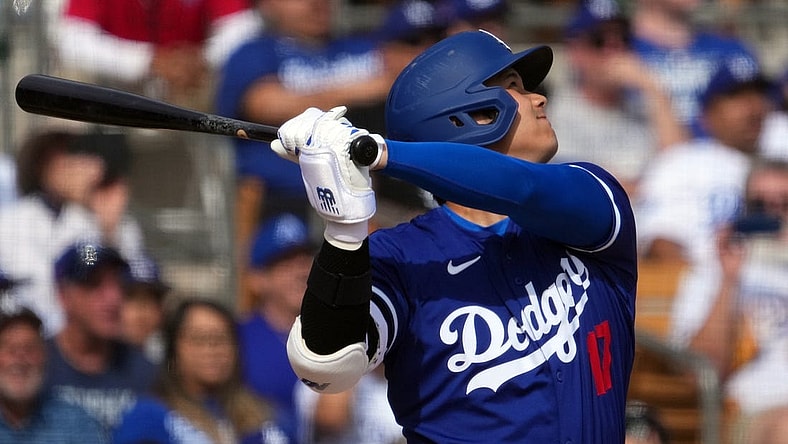 Feb 27, 2024; Phoenix, Arizona, USA; Los Angeles Dodgers designated hitter Shohei Ohtani (17) hits a two run home run during the fifth inning against the Chicago White Sox at Camelback Ranch-Glendale. Mandatory Credit: Joe Camporeale-USA TODAY Sports