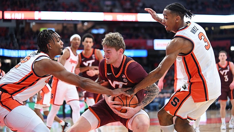 Feb 27, 2024; Syracuse, New York, USA; Virginia Tech Hokies guard Tyler Nickel is pressed between Syracuse Orange guard JJ Starling (2) and guard Judah Mintz (3) in the first half at the JMA Wireless Dome. Mandatory Credit: Mark Konezny-USA TODAY Sports