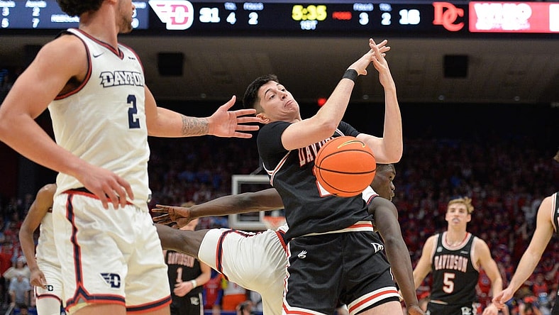 Feb 27, 2024; Dayton, Ohio, USA;  Davidson Wildcats guard Riccardo Ghedini (22) reaches for a rebound against Dayton Flyers forward Nate Santos (2) during the game at University of Dayton Arena. Mandatory Credit: Matt Lunsford-USA TODAY Sports