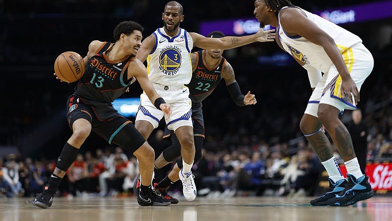 Feb 27, 2024; Washington, District of Columbia, USA; Washington Wizards guard Jordan Poole (13) drives to the basket as Golden State Warriors guard Chris Paul (3) defends in the first half at Capital One Arena. Mandatory Credit: Geoff Burke-USA TODAY Sports
