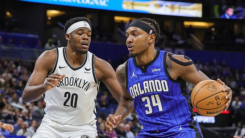 Feb 27, 2024; Orlando, Florida, USA; Orlando Magic center Wendell Carter Jr. (34) drives to the basket against Brooklyn Nets center Day'Ron Sharpe (20) during the first quarter at Amway Center. Mandatory Credit: Mike Watters-USA TODAY Sports