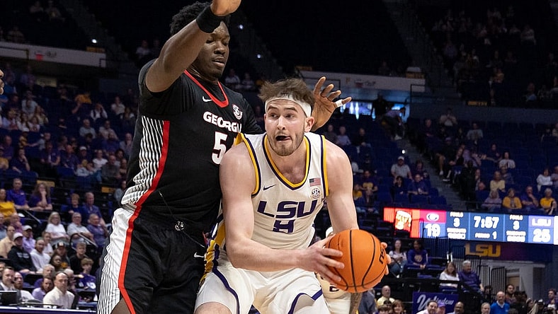 Feb 27, 2024; Baton Rouge, Louisiana, USA; LSU Tigers forward Will Baker (9) dribbles against Georgia Bulldogs center Russel Tchewa (54) during the first half at Pete Maravich Assembly Center. Mandatory Credit: Stephen Lew-USA TODAY Sports
